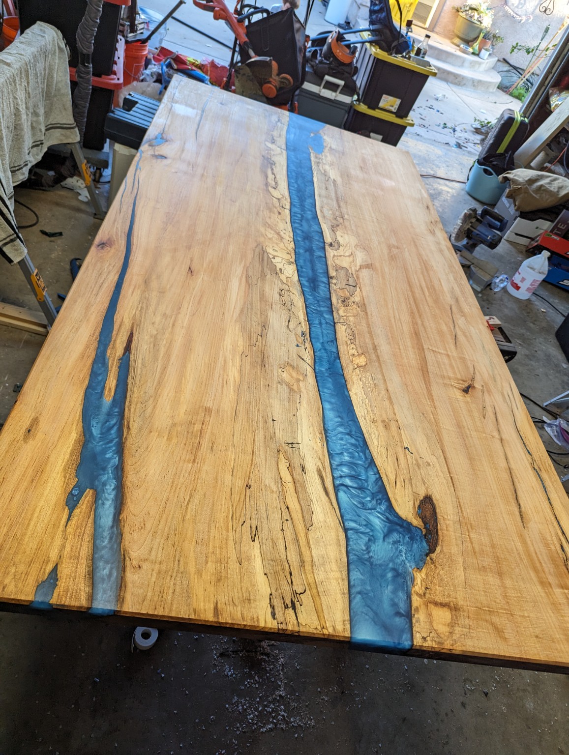 Live edge wood table with blue resin river